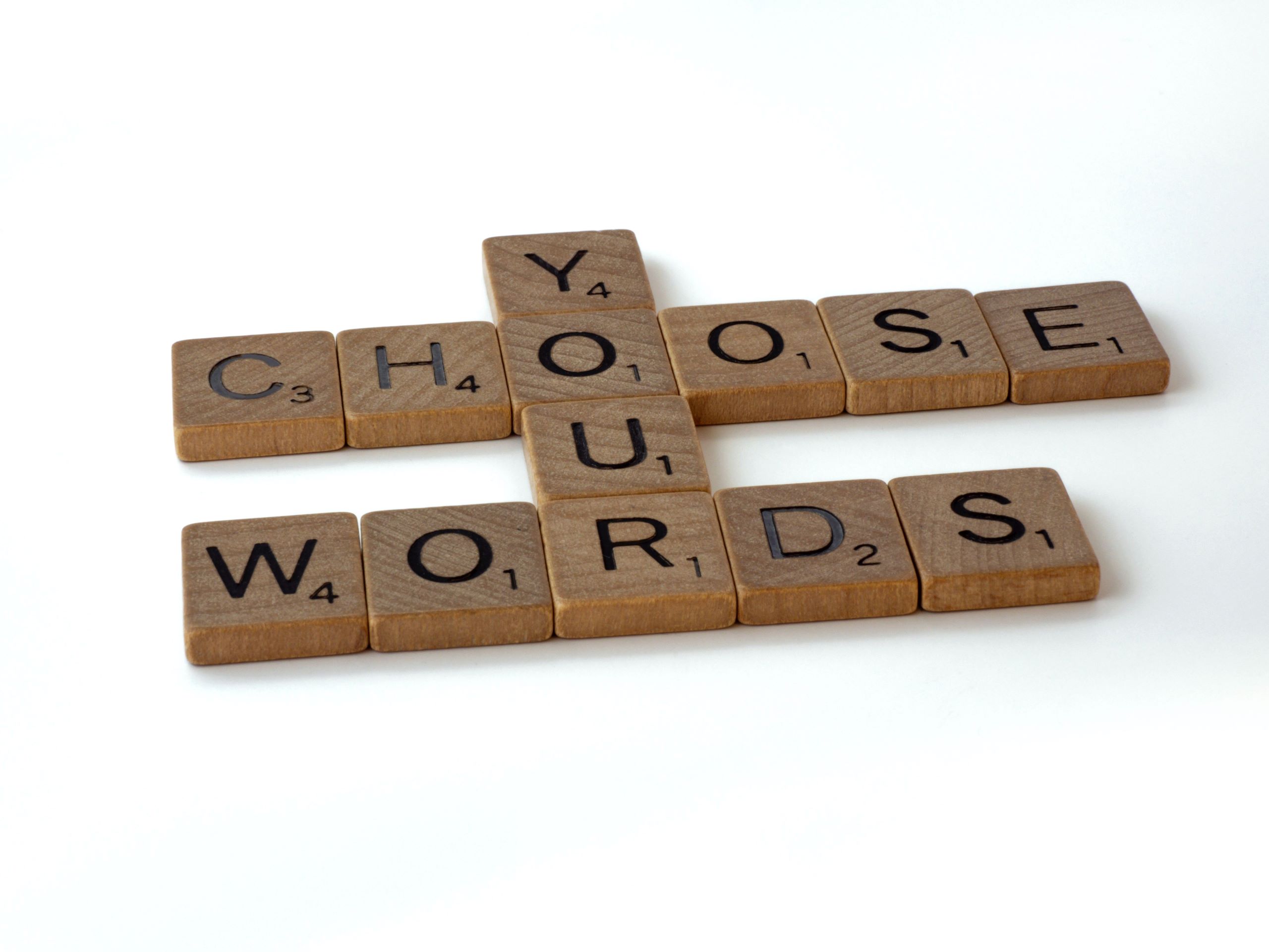 Scrabble tiles spelling the words "Choose your words"